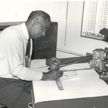 Fred McKinley Jones, innovator of mobile refrigeration trucking, works on schematics at a desk