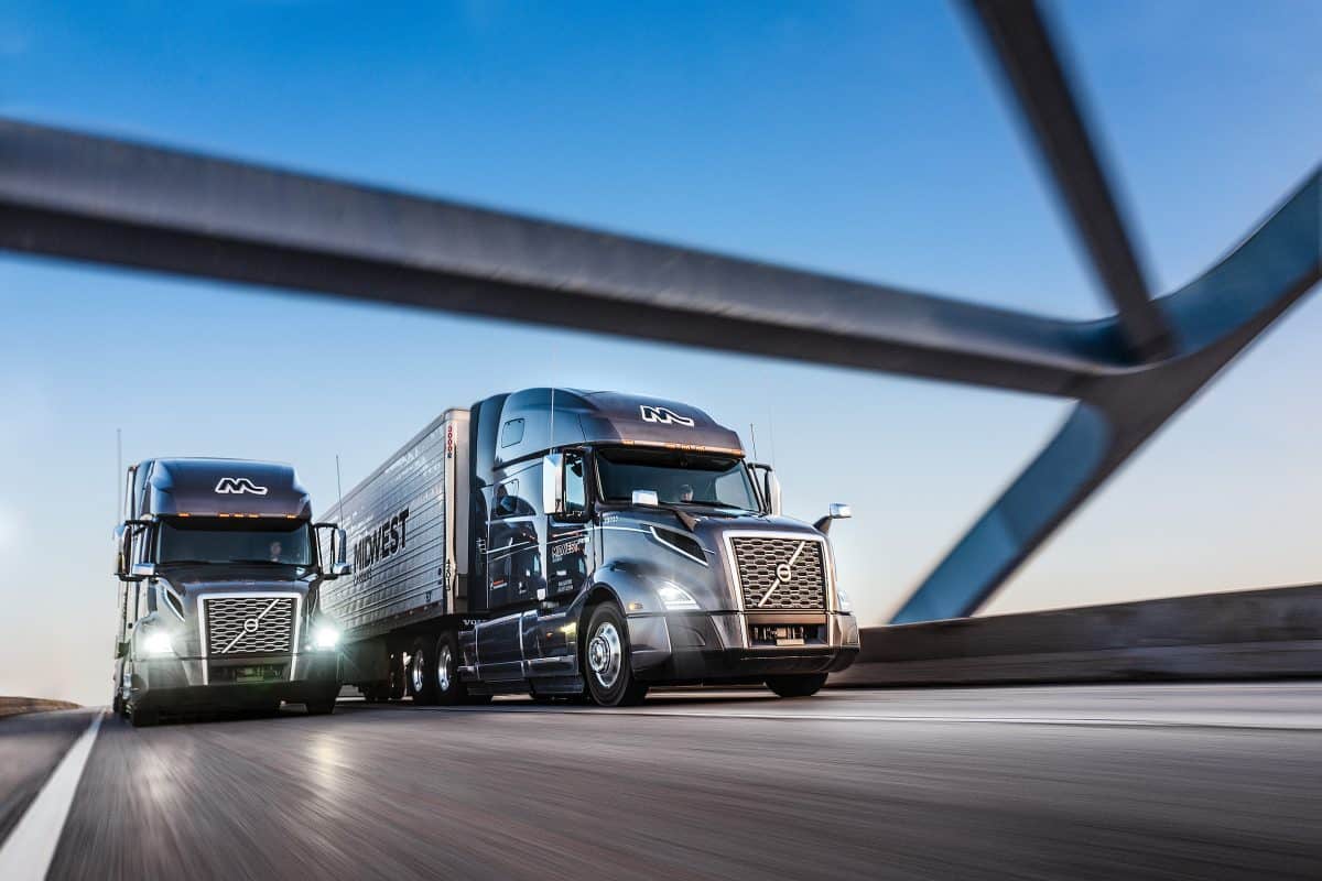 Two trucking driving on highway