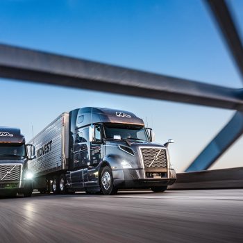Two trucking driving on highway