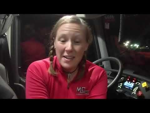 Female truck driver in cab talking about her career